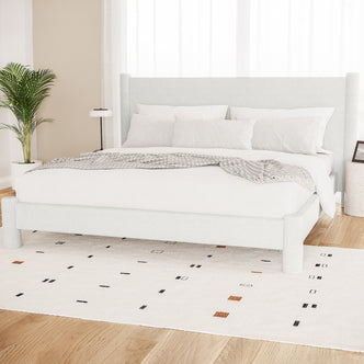 Rhoda King Upholstered Bouclé Bed in Cream White with a plush, rounded headboard and fully upholstered frame, showcasing luxurious bouclé fabric texture and solid wood construction for a grand bedroom centerpiece.