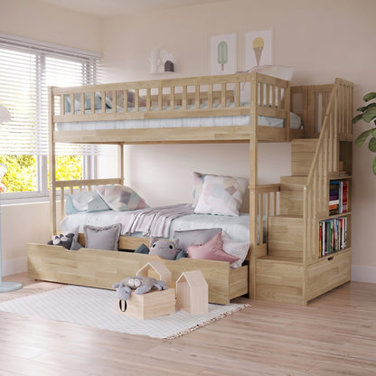 Sabbie Hardwood Single Storage Bunk Bed in Natural features a light wood finish, staircase with bookshelf, pull-out drawers, pastel bedding, geometric pillows, and plush toys against a bright, airy room backdrop.