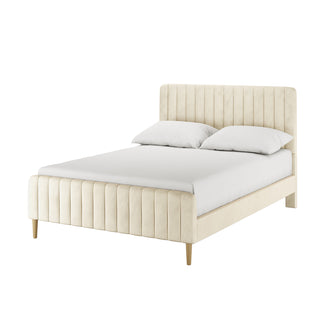 Seneca Double Upholstered Velvet Bed – Sandy White features a cream vertical channel-tufted headboard and footboard, slim tapered wooden legs, dressed with a white fitted sheet and pillows against a seamless background.