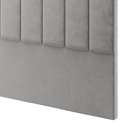 Close-up of the Septima & Gratiana Double Bed & Headboard Package – Slate, featuring a padded grey headboard with vertical tufted panels above a smooth upholstered surface, highlighting its elegant design and plush comfort.