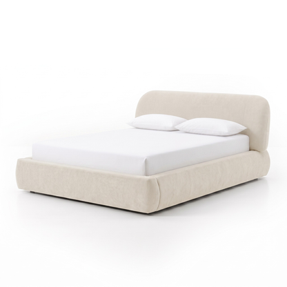 Cream upholstered bed with white bedding on a white background