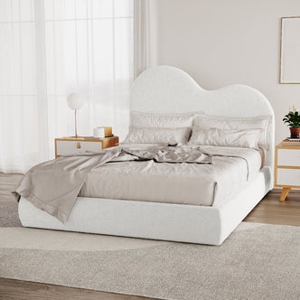 Thales Curved Boucle Bed Frame - Queen - Cream White features a curved headboard in soft boucle fabric, emphasizing modern elegance and comfort. Accentuated by the solid build and intricate design details.