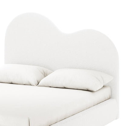 Thales Curved Boucle Bed Frame - Queen features a heart-shaped headboard, cream-white boucle fabric, and white pillow, emphasizing modern elegance and comfort.