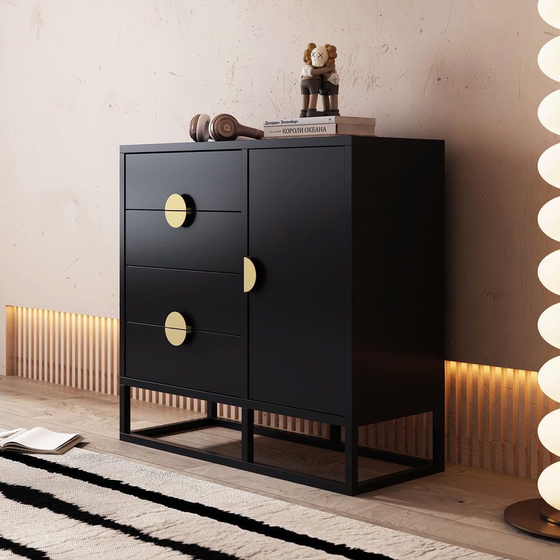Abigail 100cm Sideboard Buffet with Gold Handle - Black features a sleek design with matte-gold pulls, three drawers, a cupboard, and is topped with books, headphones, and a collectible figurine.