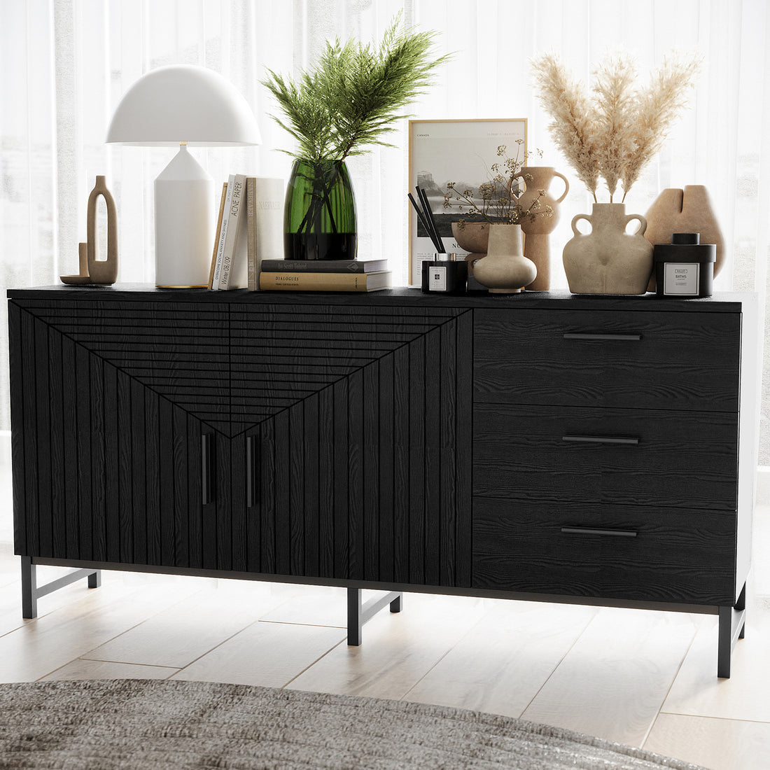 Black fluted sideboard buffet with geometric panel doors, three drawers and metal legs styled with vases, lamp and books