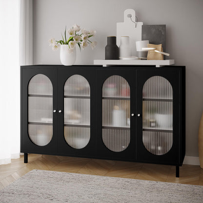 Cambria 150cm Fluted Glass Buffet Cabinet - Black with four ribbed glass doors, topped with a white vase of tulip-like flowers, decorative bottles, and a serving tray on a herringbone floor.