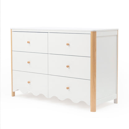 White six-drawer dresser with scalloped bottom edge and wood accents on white background