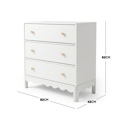 White three-drawer dresser with gold flower knobs on white background