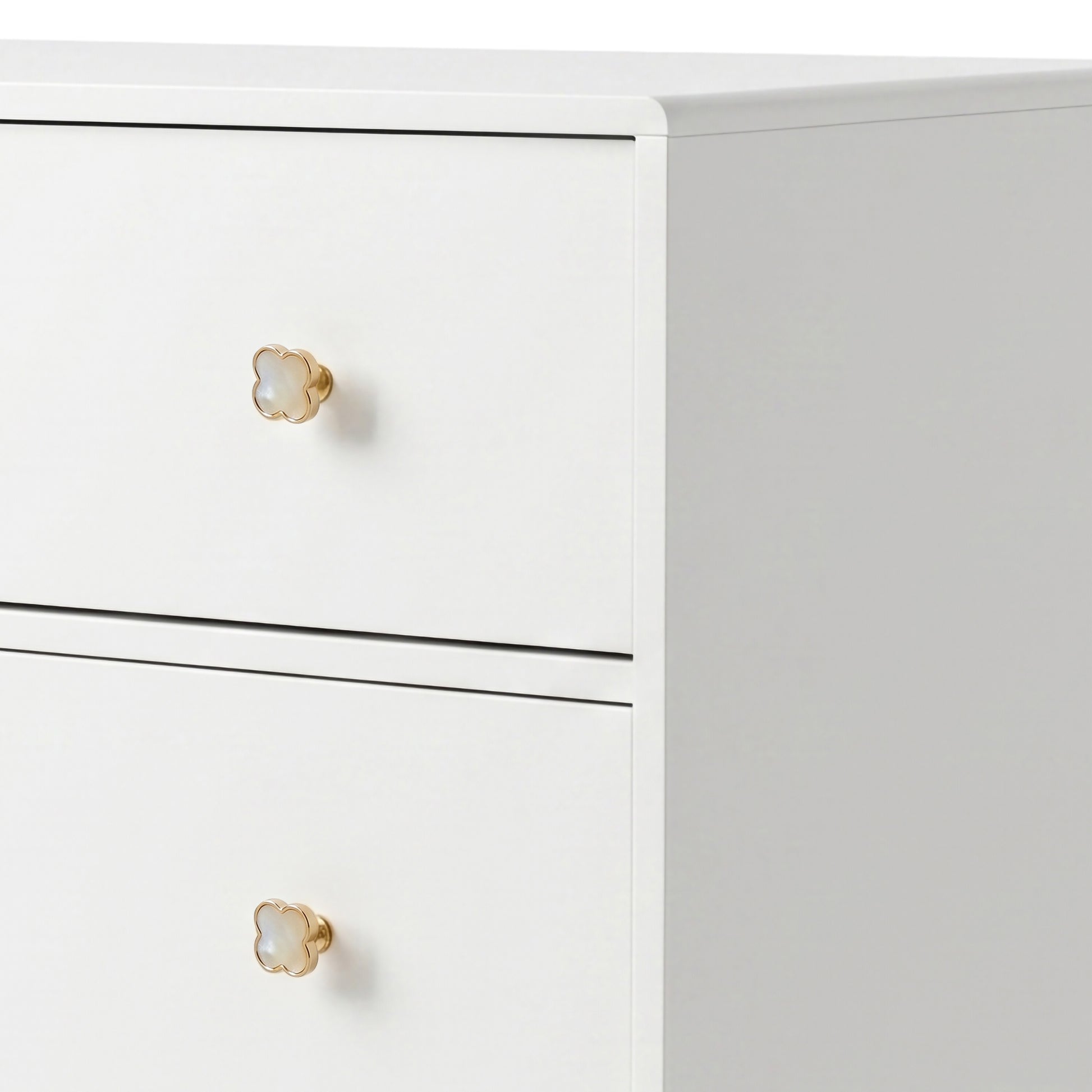 White three-drawer dresser with gold flower knobs on white background
