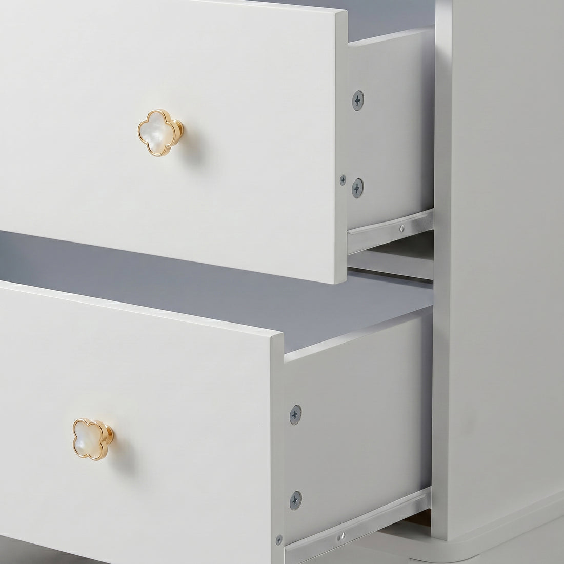White three-drawer dresser with gold flower knobs on white background