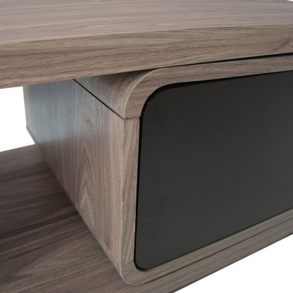 Galya Extendable Storage TV Unit - Teak, showcasing a modern wood-veneered design with a gray-brown shelf, curved compartment corners, and a matte-black front panel, ideal for sleek, organized living room setups.