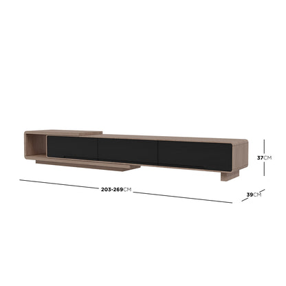 Galya Extendable Storage TV Unit - Teak features a sleek, modular design with light-toned wood, black storage doors, and an open cubby, creating a floating effect on asymmetrical supports.
