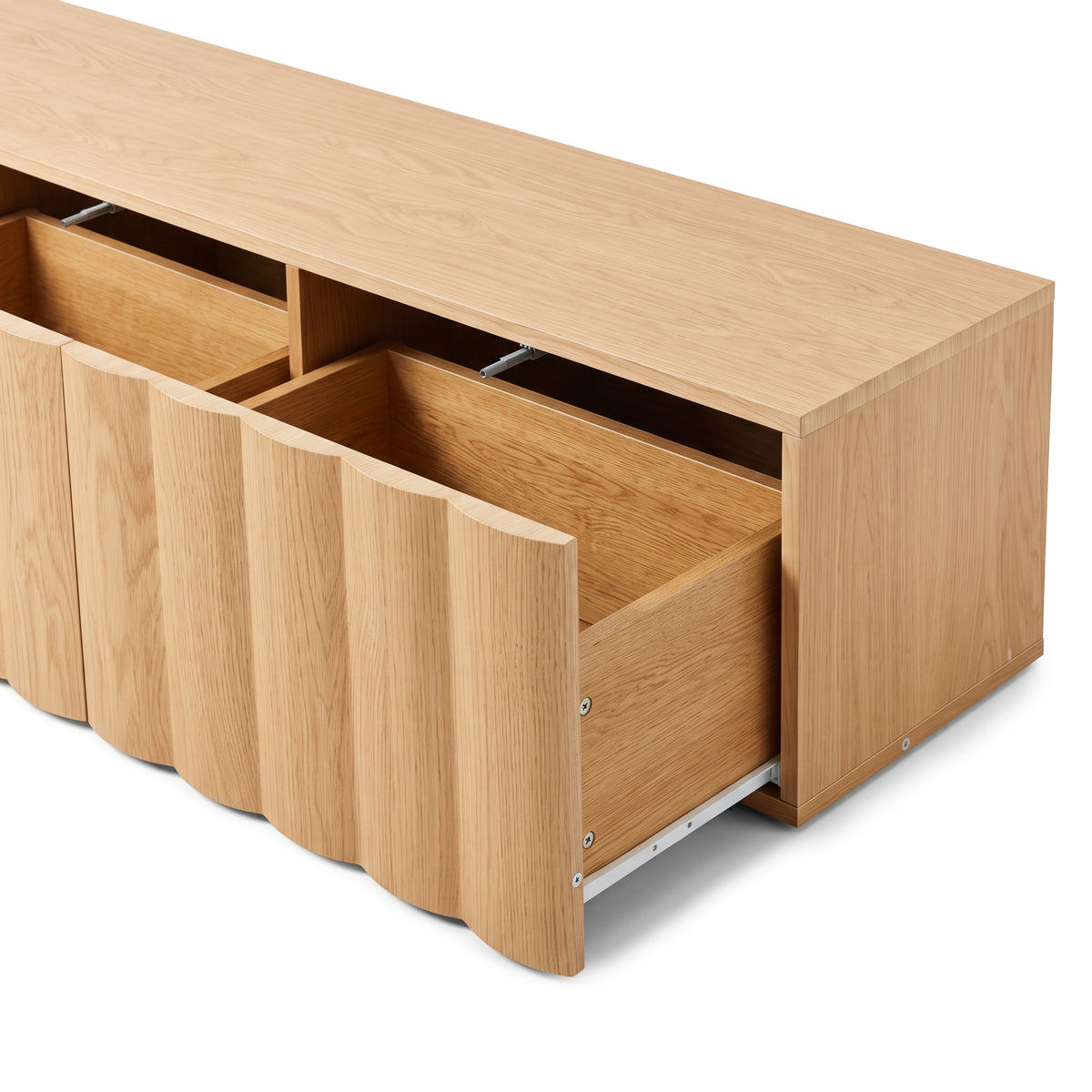 Oak TV unit with open fluted pull-out drawers revealing interior storage tracks and wood grain finish against a plain white studio background.