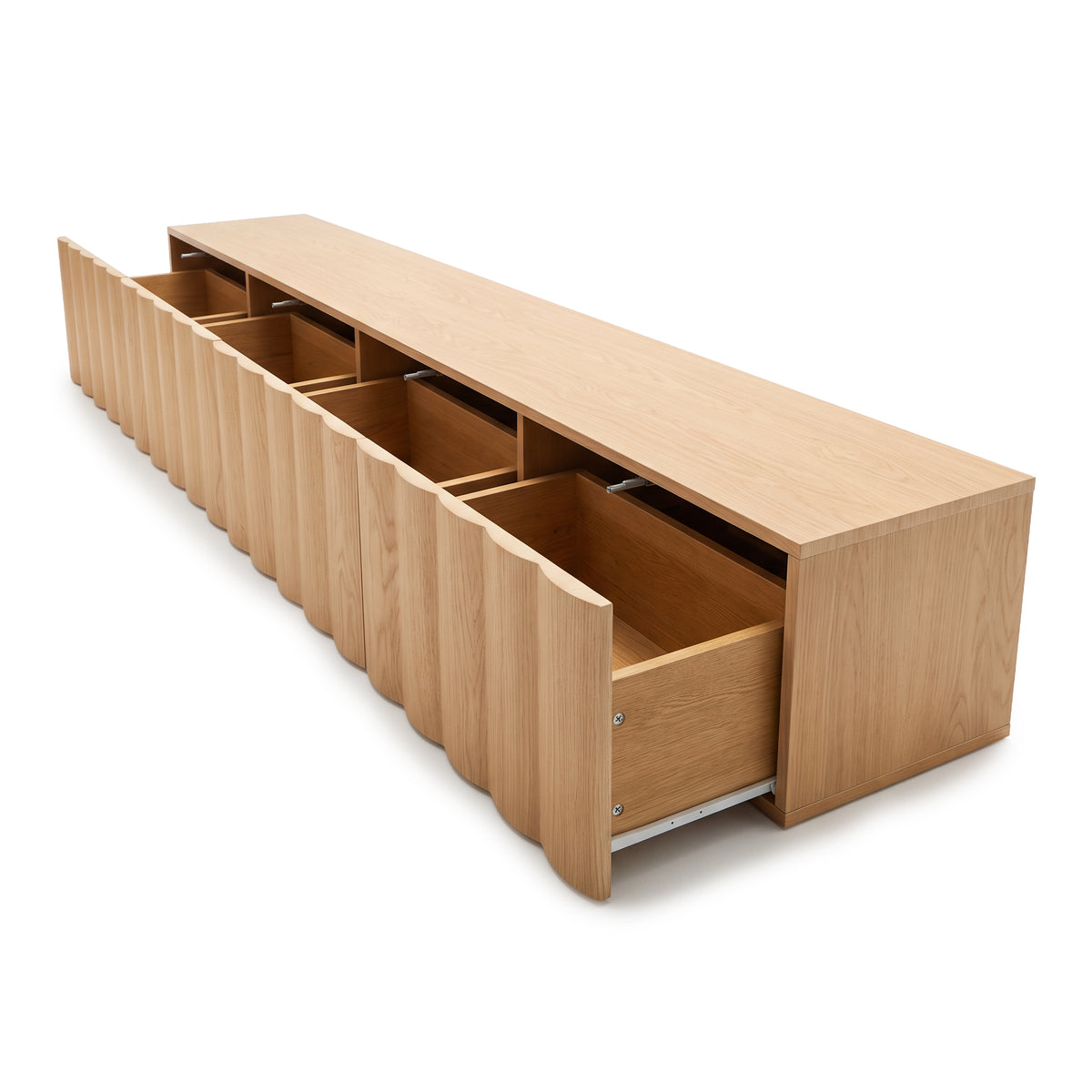 Angled view of an oak TV unit with all four fluted drawers extended open to showcase the interior storage capacity against a plain white studio background.