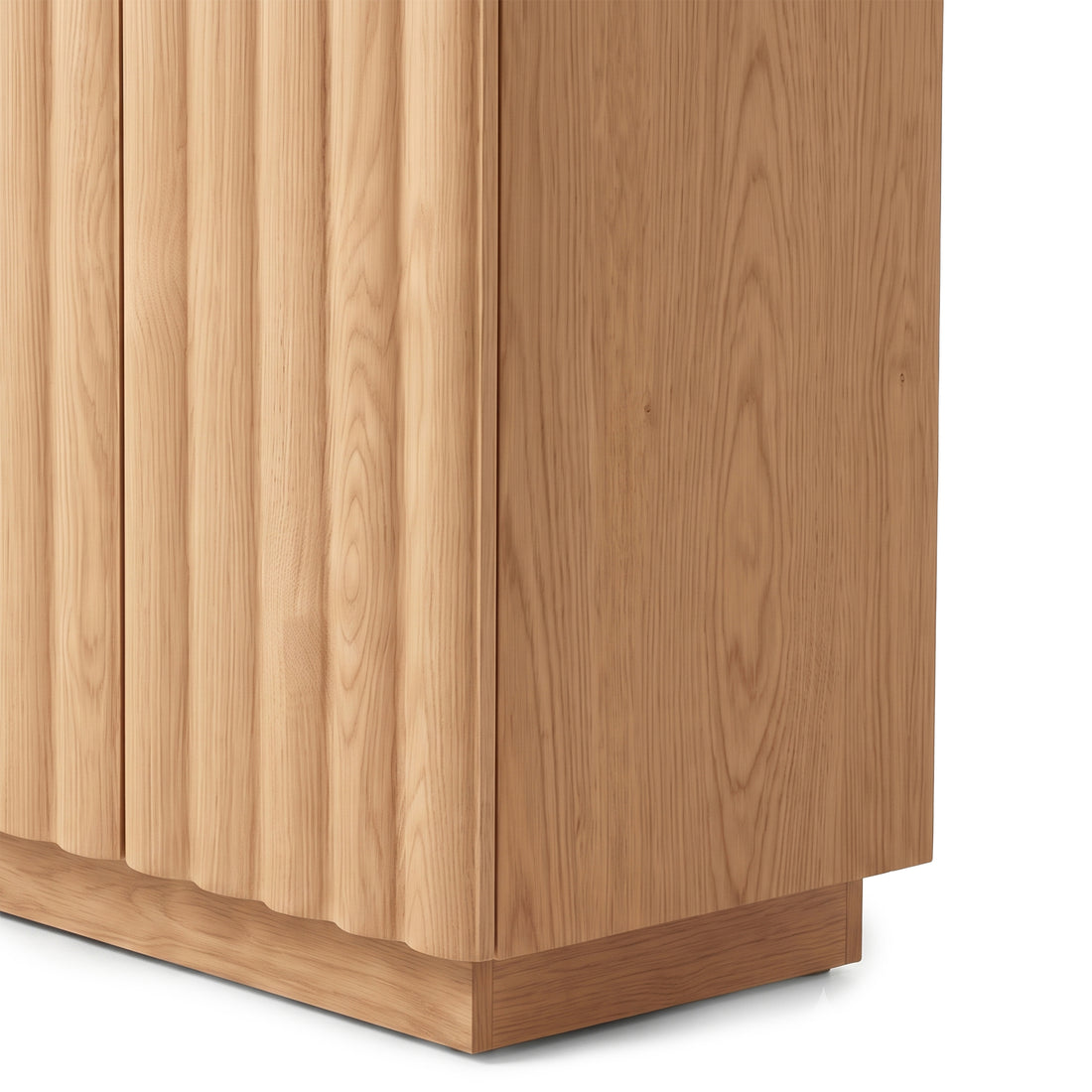 Close-up view of an oak sideboard highlighting the natural wood grain texture and vertical fluted door detailing against a plain white studio background.