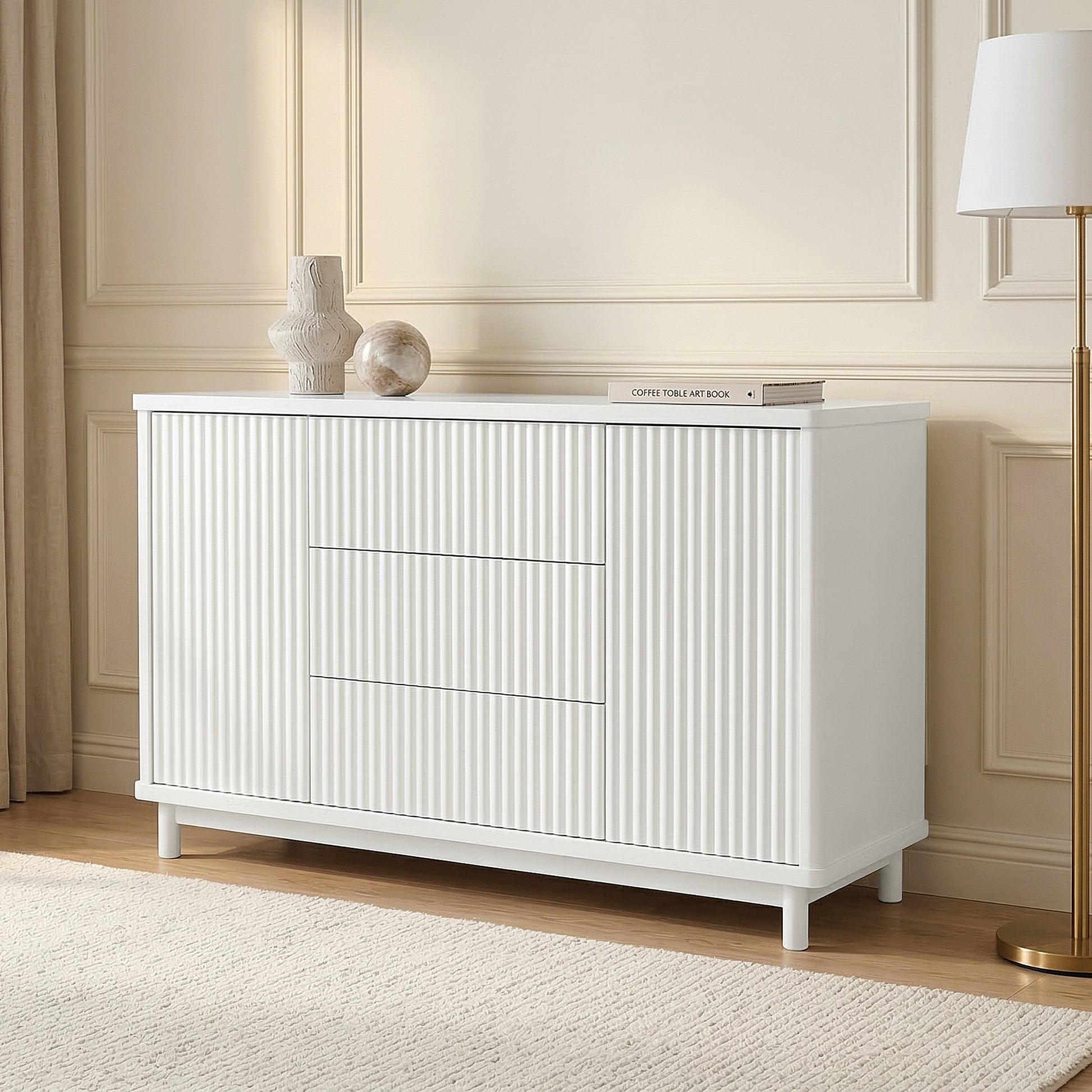 White dresser in a styled living room setting