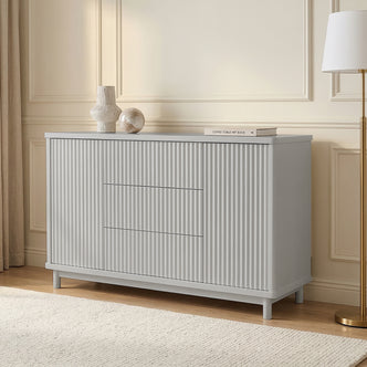 Light gray sideboard in styled living room with vases and lamp