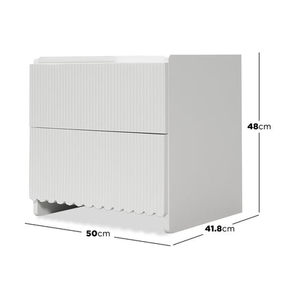 Nasrin 2 Drawer Bedside Table in White, featuring a compact design with vertical fluted drawer fronts, smooth finish, and scallop-inspired edges, ideal for modern bedroom aesthetics and practical storage.