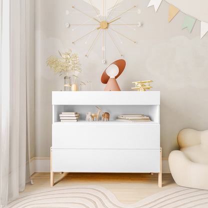 Quinta Tallboy Dresser with Drawers White & Natural featuring two soft-close drawers, an open shelf with books and toys, topped with a lamp, vase, and decor, set in a tranquil room corner.