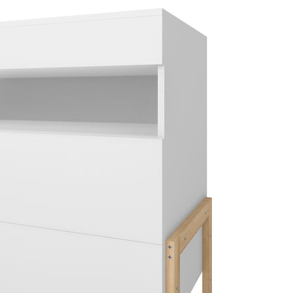 Close-up of the Quinta Tallboy Dresser with Drawers White & Natural, showcasing its minimalist all-white cabinet with a light-oak support frame, featuring a shallow open cubby near the top.