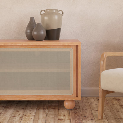 Thea 200cm Solid Oak Rattan Entertainment Unit showcases natural rattan sliding doors and sturdy timber legs, providing a blend of elegance and practicality for modern living spaces.