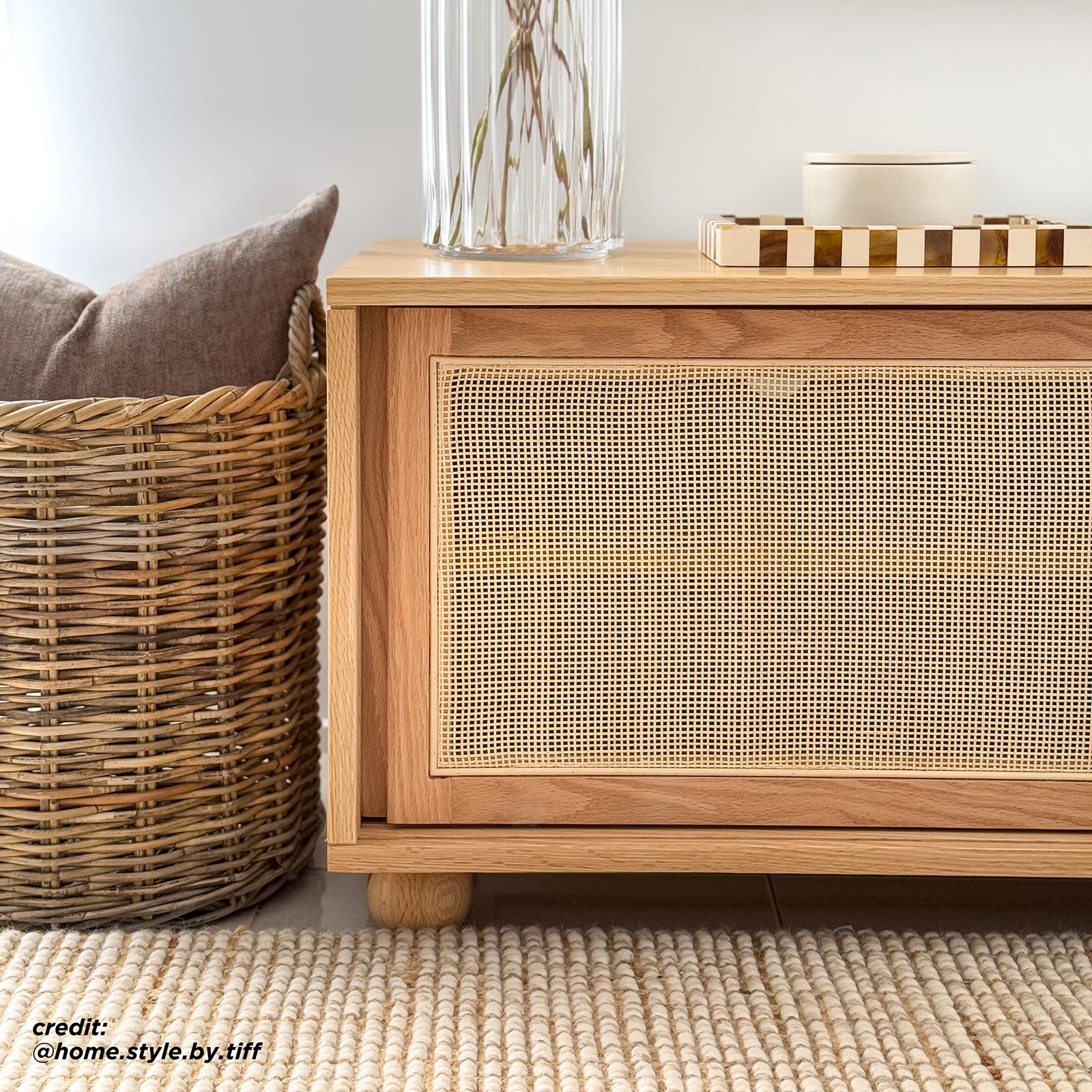 The Thea 200cm Solid Oak Rattan Entertainment Unit - Natural features elegant natural rattan sliding doors, sturdy timber legs, and ample storage, showcasing a blend of practicality and refined design.
