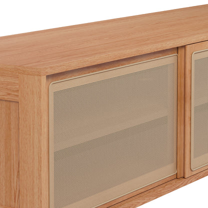 The Thea 200cm Solid Oak Rattan Entertainment Unit - Natural features a close-up of its solid oak surface and intricate rattan sliding doors, showcasing its elegant design and craftsmanship.