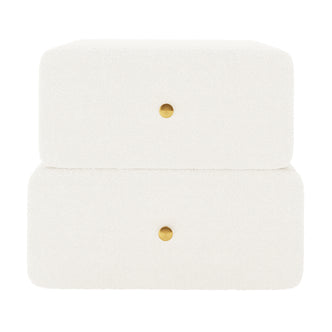 Tyla Boucle Bedside Table in Cream White, features a minimalist two-tier design with textured bouclé upholstery, two drawers each with a central brass-tone knob, enhancing bedroom elegance and functionality.