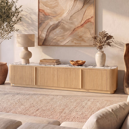 Natural wood TV unit with ribbed doors, marble-look top, rounded edges in styled living room