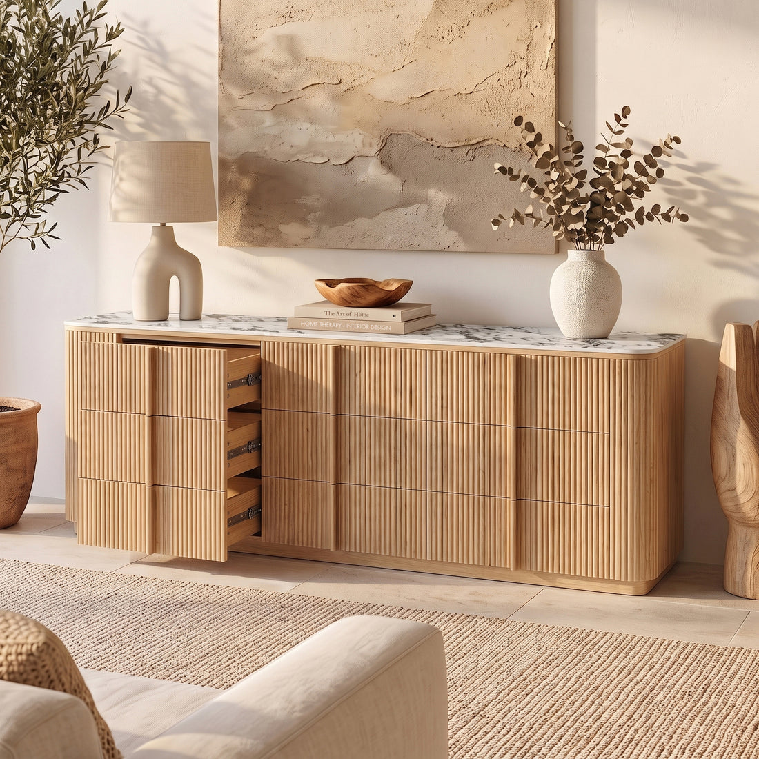 Natural wood sideboard with sintered stone top and open drawers in styled living room
