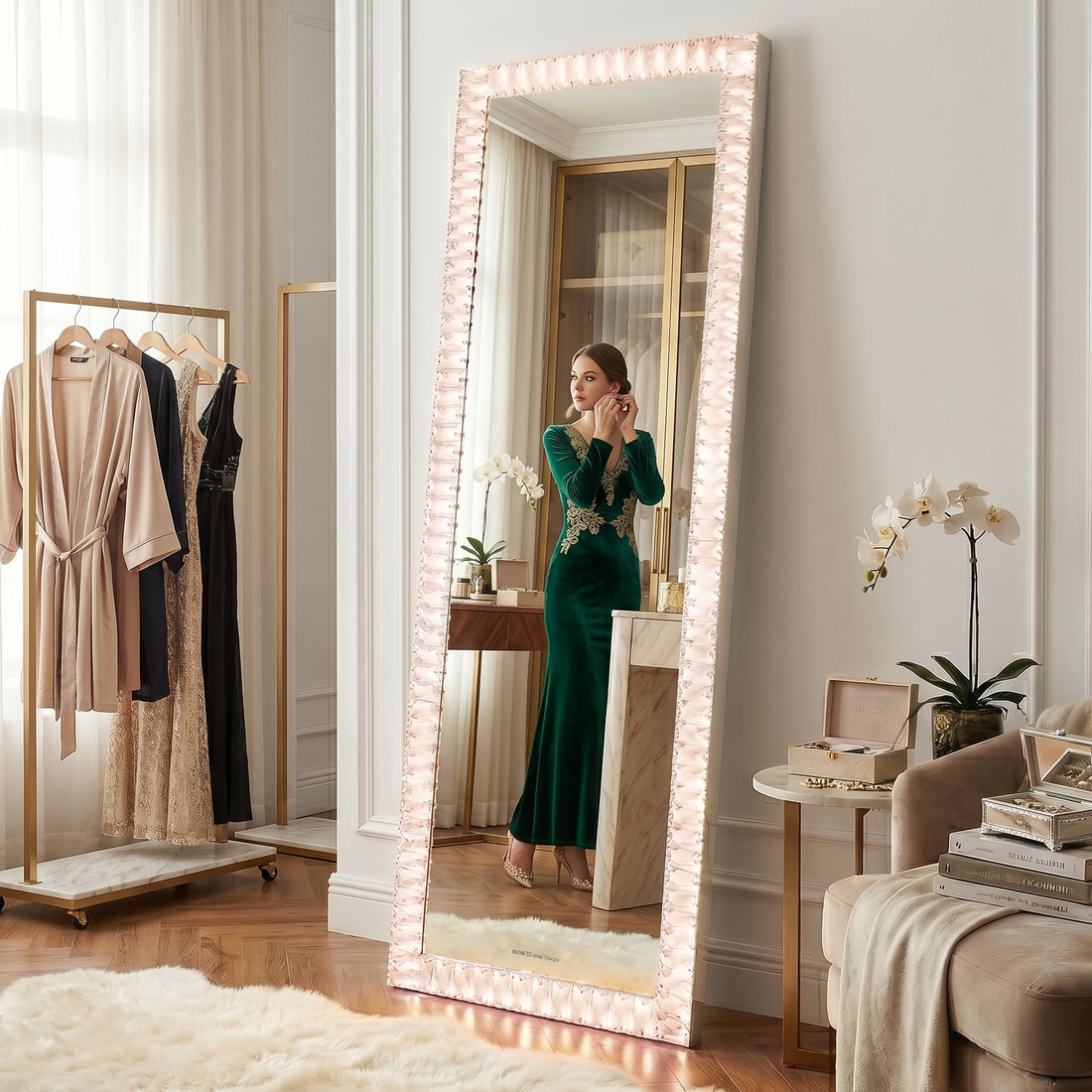 Eldor 160cm Crystal LED Full Length Mirror with pink LED lights, showcasing a woman in an emerald gown reflected, surrounded by elegant details like a gold clothing rack and plush furnishings.