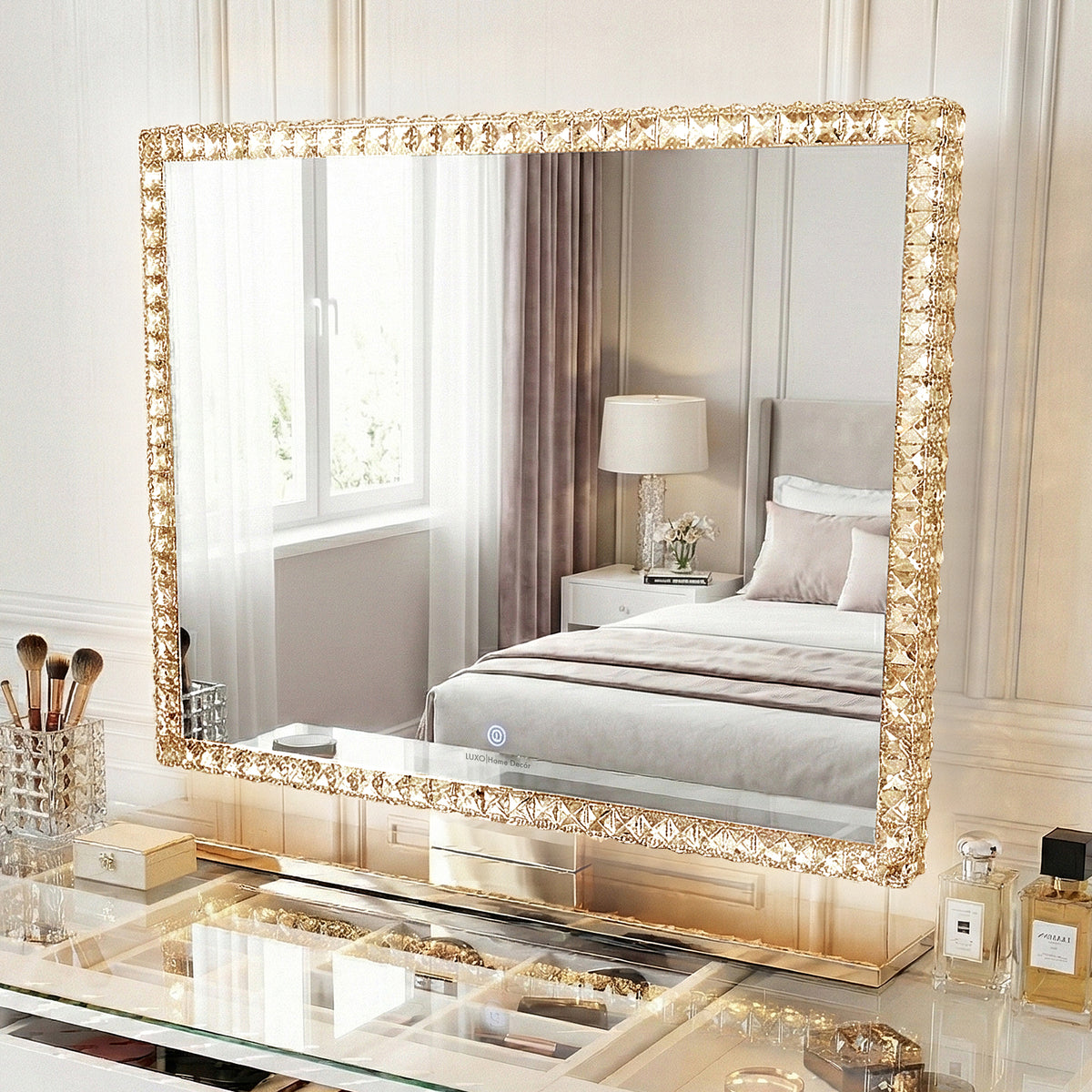 Rectangular crystal-bordered vanity mirror with LED lights on a styled vanity in a bedroom