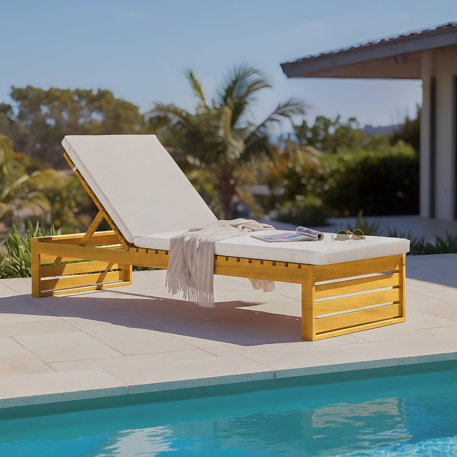 Timber outdoor sun lounger with adjustable backrests and cream cushions, situated poolside on a stone patio.