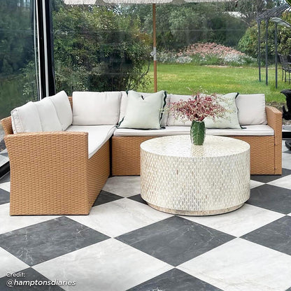 Ballena 6 Seater Wicker Outdoor Dining Sofa Set features a PE wicker sofa with padded cushions and a matching dining table with a glass top, enhancing any contemporary outdoor space.