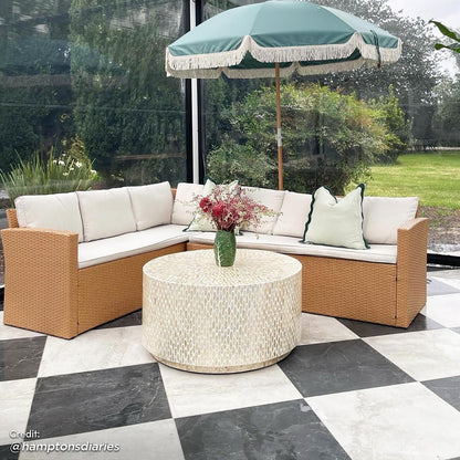 Ballena 6 Seater Wicker Outdoor Dining Sofa Set – Beige/Light Beige features a wicker sectional with plush cushions and a glass-top dining table, set on a patio with decorative vases and a couch nearby.