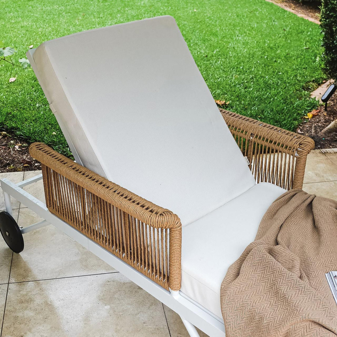 Boonoo Premium Aluminium Outdoor Rattan Sun Lounger - Cream White on a grassy outdoor setting, featuring adjustable reclining positions and plush cushions, perfect for comfortable outdoor relaxation.