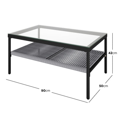 Brujas 4 Seater Wicker Outdoor Lounge Set in Grey features a rectangular coffee table with a clear glass top, black metal frame, and grey woven-rope shelf, measuring 90x50x42 cm.