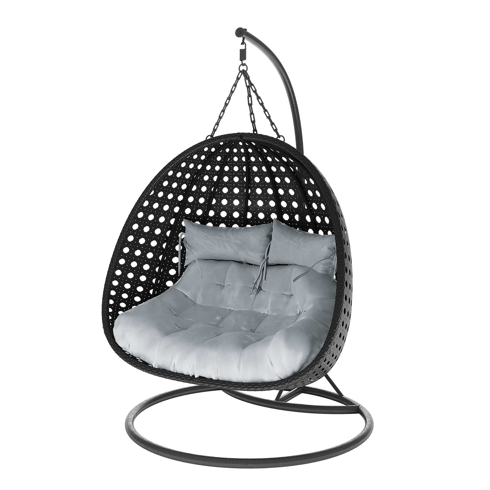 Buena 2 Person Wicker Outdoor Hanging Egg Chair in Black, features a freestanding rattan shell suspended by chains, with a round metal base and curved arm, housing thick tufted cushions for comfort.