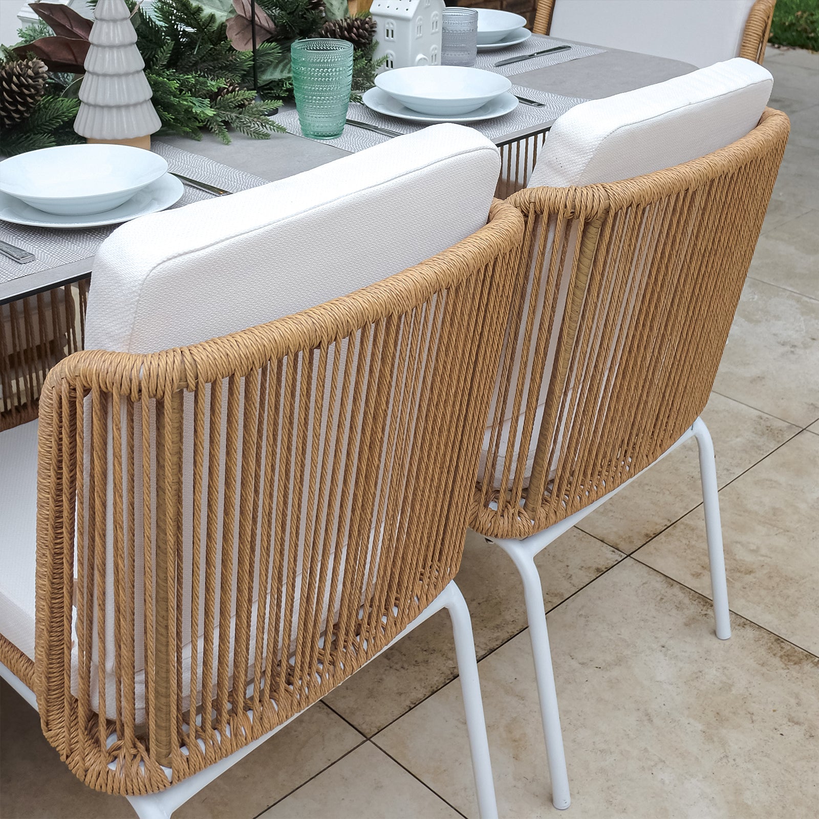 Craigie Premium 6-Seater Outdoor Dining Set features a sleek ceramic glass table with a marble-like pattern and sturdy wicker chairs, ideal for stylish and durable outdoor dining.