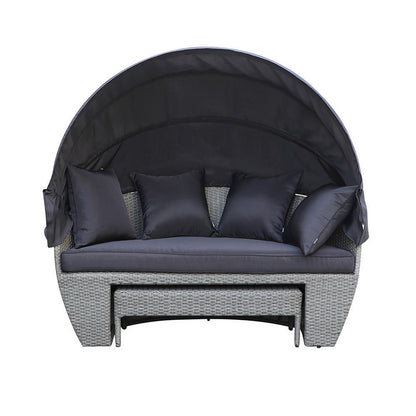Erith Wicker Outdoor Furniture Day Bed w/ Canopy Brown/Black, featuring a plush black pillow on a stylish wicker frame, complemented by a canopy for shade, displayed on a couch-style setting.
