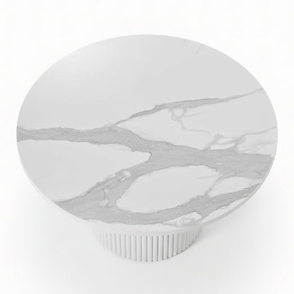 Evone 4 Seater Stone Outdoor Dining Table Set: Features a round, white marble tabletop with light veining on a fluted cylindrical base, ideal for stylish alfresco dining.

