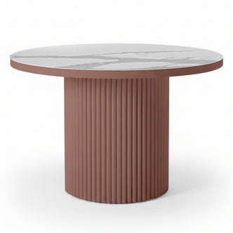 Evone Aluminium Outdoor Dining Table in Terracotta features a round white marble-look top and a fluted, cylindrical dusty-rose base, offering a contemporary, stylish look for outdoor spaces.
