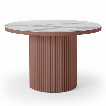 Evone Aluminium Outdoor Dining Table in Terracotta features a round white marble-look top and a fluted, cylindrical dusty-rose base, offering a contemporary, stylish look for outdoor spaces.
