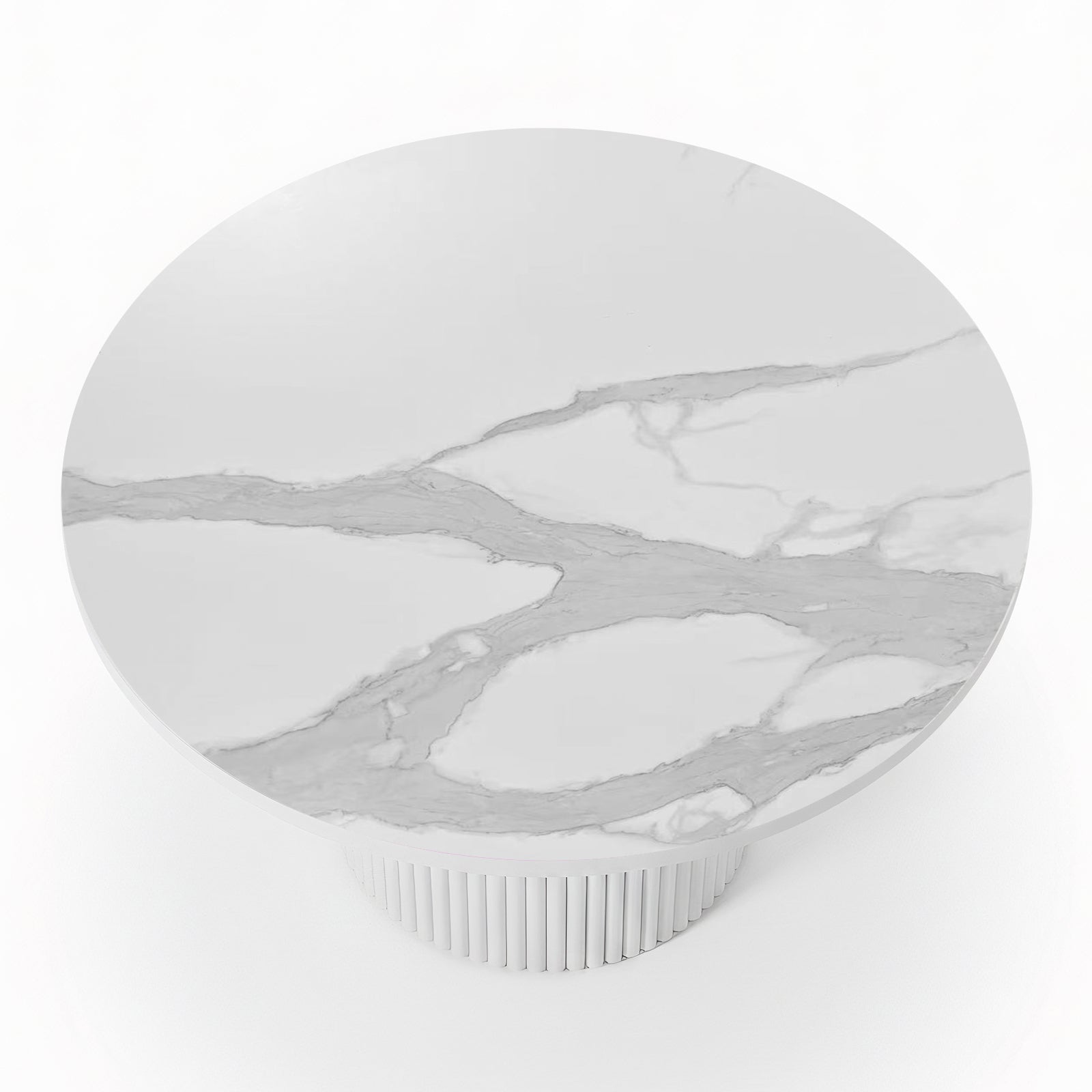 Close-up of a round dining table featuring a white stone top with grey marble veining and a white fluted pedestal base_3