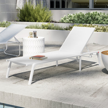 Jabari Textilene Aluminium Outdoor Sunbed in Cream White with adjustable backrest, white metal frame, and two stacked books. Nearby, a side table with tumbler and jar, set by a pool.
