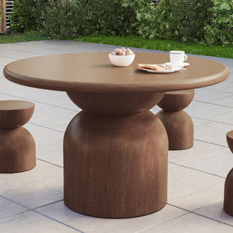 Krates 120cm Round Indoor/Outdoor Concrete Dining Table Chestnut on a patio, showcasing its modern design and spacious round surface, ideal for outdoor gatherings or indoor dining.