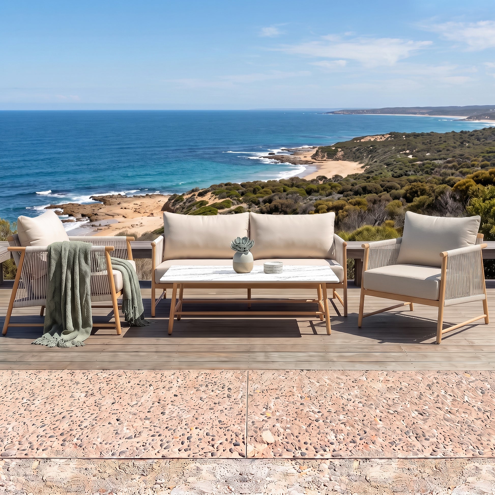 Outdoor furniture set on a deck overlooking the ocean