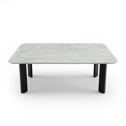 Rectangular coffee table with stone-look top and black legs on a white background