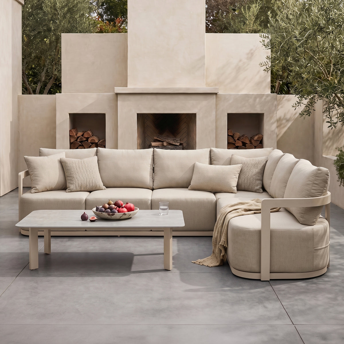 Outdoor beige sectional sofa set with coffee table styled on a patio in a real-life setting
