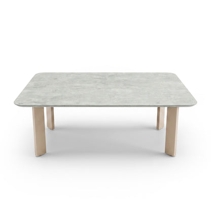 Rectangular table with light top and wood legs on a white background